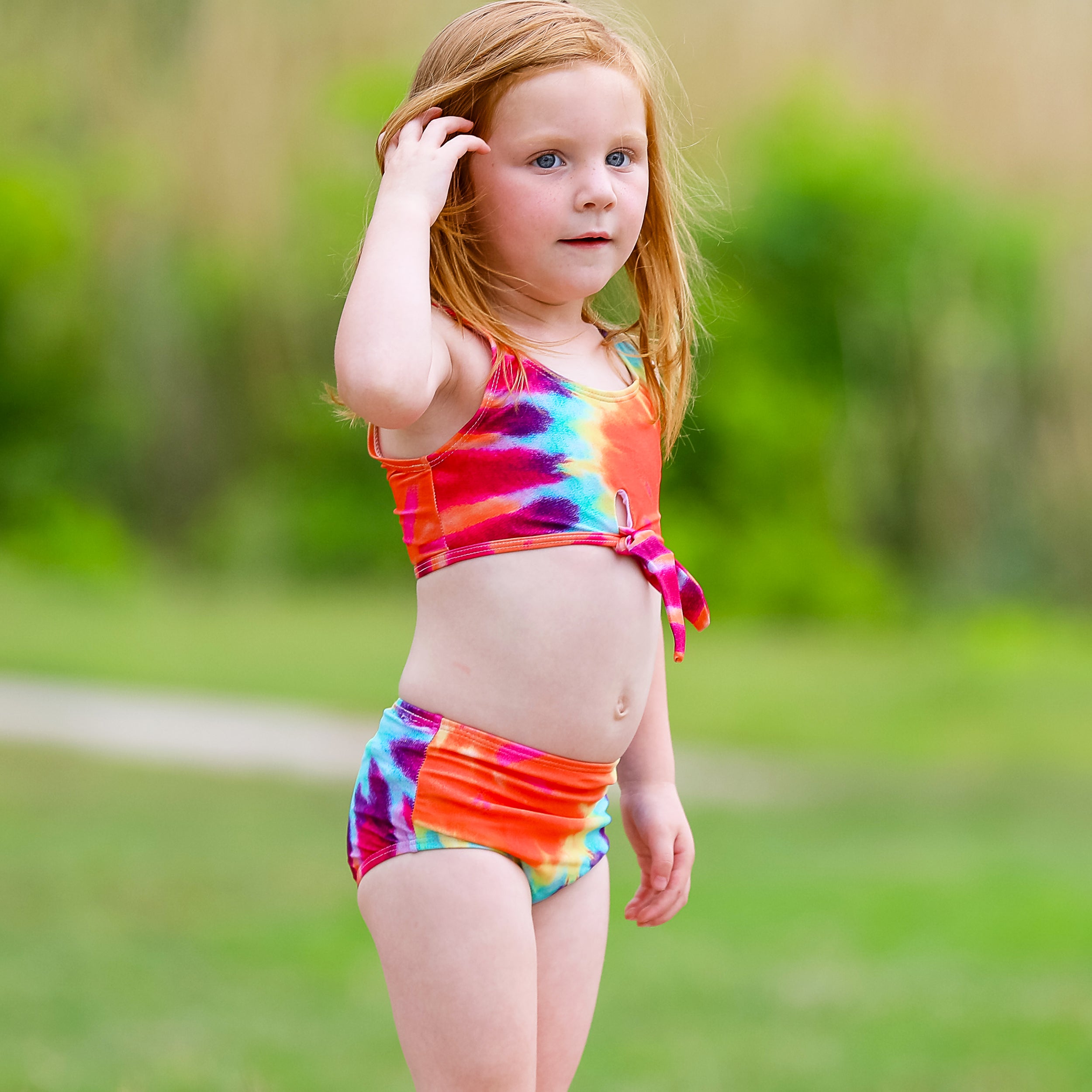 AL Limited Girls 2 piece Tie Dye Tankini Swimsuit featuring a rainbow swirl design with a tie knot tank top and high-waisted bottoms.